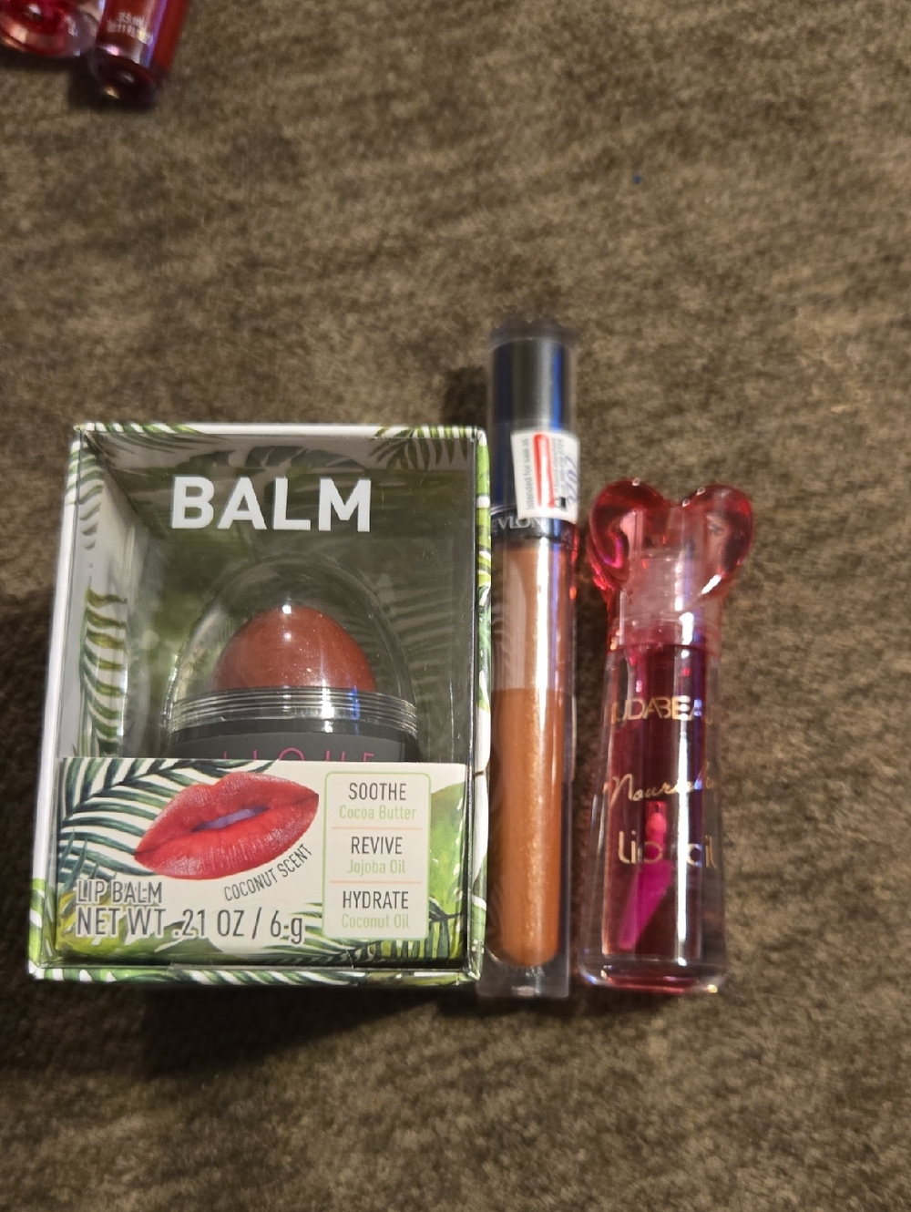 Revlon Lip Gloss, Huda Beauty Lip Oil, And Lip Balm